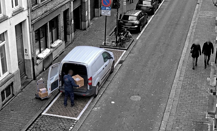 Truck with back doors open unloading boxes in a delivery area